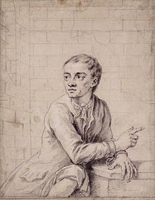 A pencil sketch of a man with short hair sitting in a stone room with chains on his wrists