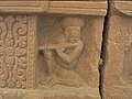 A detail from the Mỹ Sơn E1 pedestal shows a flutist playing his instrument.