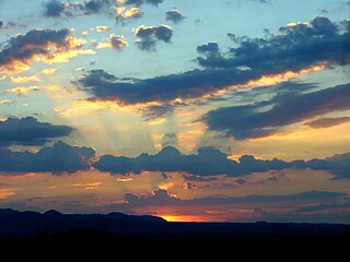 Particles in the atmosphere and the sun's angle enhance colors of stratocumulus cumulogenitus at evening twilight.