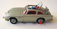 a silver-coloured toy car showing a plastic man being ejected through the roof.