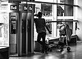 "Man_talking_on_the_phone_in_Montréal-Pierre_Elliott_Trudeau_International_Airport_006.jpg" by User:Wilfredor