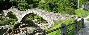 Stone arch bridge spanning a river.