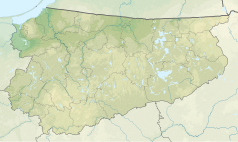 Mapa konturowa województwa warmińsko-mazurskiego, po prawej znajduje się punkt z opisem „źródło”, natomiast blisko prawej krawiędzi nieco na dole znajduje się punkt z opisem „ujście”