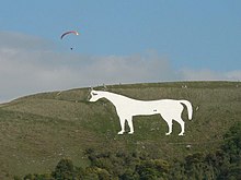 Figure of a white horse cut into the hillside.