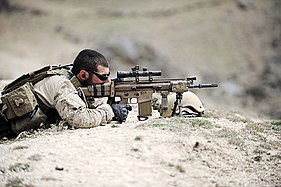 A SEAL takes up a defensive position in a village in northern Zabul province, Afghanistan, 10 April 2010.