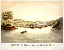 Colored lithograph of Pittsburgh as seen in 1817. The view is panoramic, showing two rivers merging toward the viewer in the foreground, with the small city of Pittsburgh in the middle of the view and low, partially wooded hills in the background. Adamson Tannehill's estate of Grove Hill is standing alone on the slope of a hill in a clearing in the background. Three small boats are on the river, with the smoke and bow of a large steamboat barely visible turning the bend in one of the rivers in the distance.