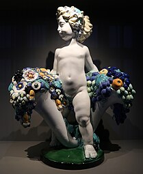 Secessionist putto with two cornucopias with floral cascades, by Michael Powolny, designed in c. 1907, produced in 1912, ceramic, Kunstgewerbemuseum Berlin[17]