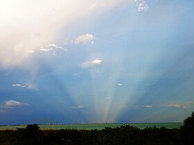 Anticrepuscular rays opposite the setting sun off the Florida Gulf Coast of the United States