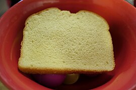 Bread in red bowl of easter eggs with camera rotated a little.jpg