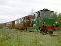 RTM-Dampflok 50 vor einem Personenzug an der Remise