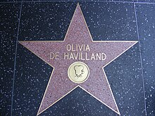 Five-pointed star with her name and an image of an old film câmera