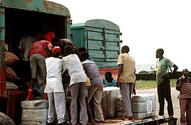 Local personnel break down pallets and load trucks with supplies that will be driven to Rwanda to the refugee camps - DPLA - 994846977164dc2262f57fffe99c51ea.jpeg