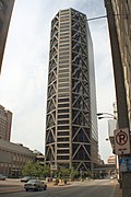 A tall building with a triangular frame on the exterior.