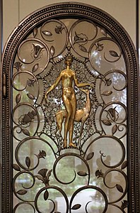 Art Deco volutes on a pair of elevator doors, by Edgar Brandt, 1926, wrought iron, glass, and patinated and gilded bronze, Calouste Gulbenkian Museum, Lisbon[15]