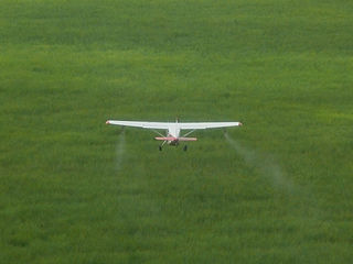 Cessna of the International Red Locust Control Organization spraying red locusts in Iku Katavi National Park, Tanzania, 2009