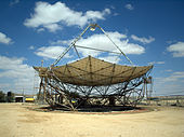 A horizontal parabolic dish, with a triangular structure on its top.