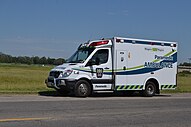 A Mercedes Sprinter ambulance in the Niagara Region of Ontario, with small half-Battenburg markings in Oxford blue and green.