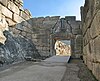 A ruined prehistoric gate built by massive stones. A relief of two lions stands above the entrance.