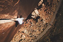 A climber doing the arm jamming technique