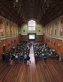 This is a photograph of the interior of Bonython Hall, a venue for graduations and other events, during a public forum on nuclear energy.