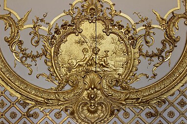 Rococo cartouche with putti in the Cabinet de la Pendule, Palace of Versailles, France, created and sculpted by Jacques Verberckt,1738[15]