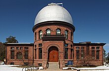 A brick building with silver domed roof.