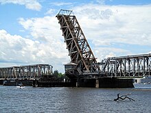 A large railway bridge over a wide river