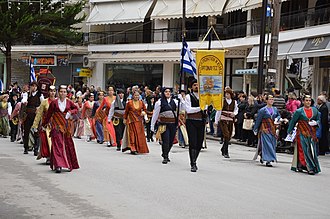 People marching down a street, carrying banner