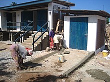 People constructing a ramp for an accessible bathroom