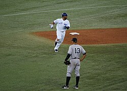 Encarnacion looks on with a smile after Lind brings him around with a home run. (8034641282).jpg