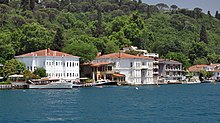 Two- and three-story colored houses with docks and balconies, built directly on the edge of the water