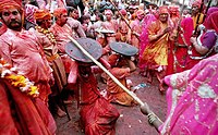 In the Braj region of North India, women have the option to playfully hit men who save themselves with shields; for the day, men are culturally expected to accept whatever women dish out to them. This ritual is called Lath Mar Holi.[95]