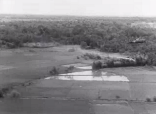 French plane pulling up after a dive to drop Napalm bombs on Vietminh force ambushing a French battalion. The white streak below the plane, clearly visible against the dark background of trees further behind, was the Napalm bomb that was just dropped. 1953 December.