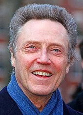 A photograph of a smiling Christopher Walken