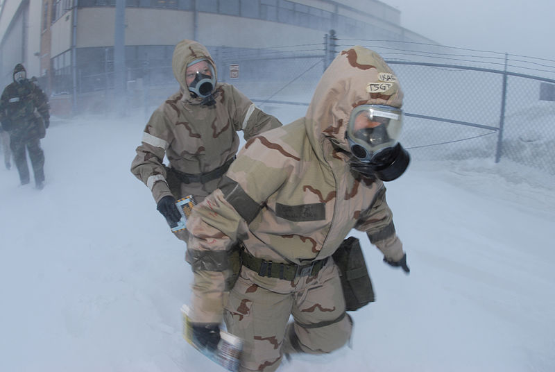 File:From right, U.S. Air Force Tech. Sgt. Jacy J. Vogelewede and Airman Rebecca M. Hanson, both of the 119th Aircraft Maintenance Squadron, make their way through harsh winds and snow in their chemical warfare gear 080209-F-WA217-037.jpg