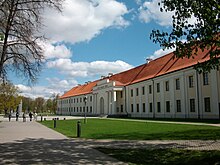 Long, two-story building with a red roof