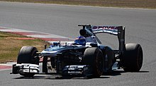 Susie Wolff driving a F1 car exiting a turn