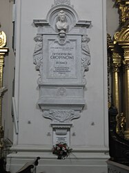 Monumento funerario su un pilastro nella chiesa di Santa Croce, Varsavia, che racchiude il cuore di Chopin (appena sopra il mazzo in basso)