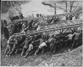 US troops launching a Bailey bridge across a gap by hand