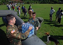 US Navy 051016-N-5526M-029 U.S. Army Warrant Officer Jeremy Bennett and Specialist Ryan Becker unload food, water, and medicine from a U.S. Army UH-60 Blackhawk helicopter during relief efforts for victims of Hurricane Stan.jpg