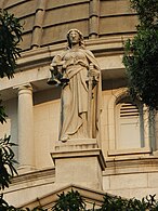 Statue of Tames, the goddess of justice, standing on the building of the Court of Final Appeal