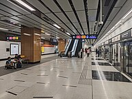 Platform F of the station with the train on the right