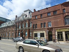 View of Trefann Court along Queen Street East, west of Sumach Street