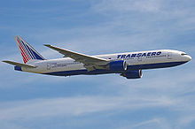 Aircraft in flight. Side view of twin-engine jet in the sky.