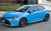 A blue Corolla parked on a residential street