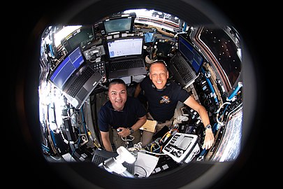 NASA astronauts Kjell Lindgren and Bob Hines monitor Starliner