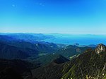 Hills covered by tropical vegetation and sea in the background