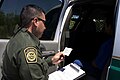 Border Patrol agent reads the Miranda rights to a Mexican national arrested for transporting drugs