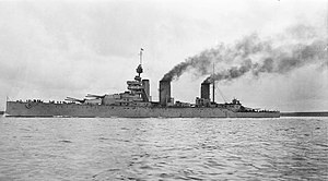 Three-stacked, dark grey warship at sea