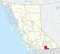 A map of British Columbia depicting its 28 regional districts and equivalent municipalities. One is highlighted in red.